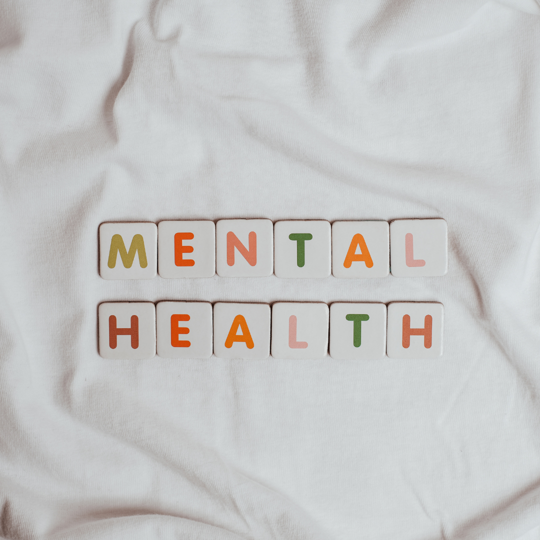 Photo of the word Mental Health spelt out on a white fabric