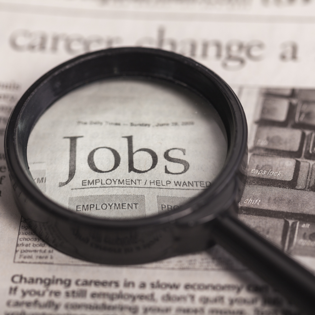 Photo of a journal with the word Jobs and a magnifying glass