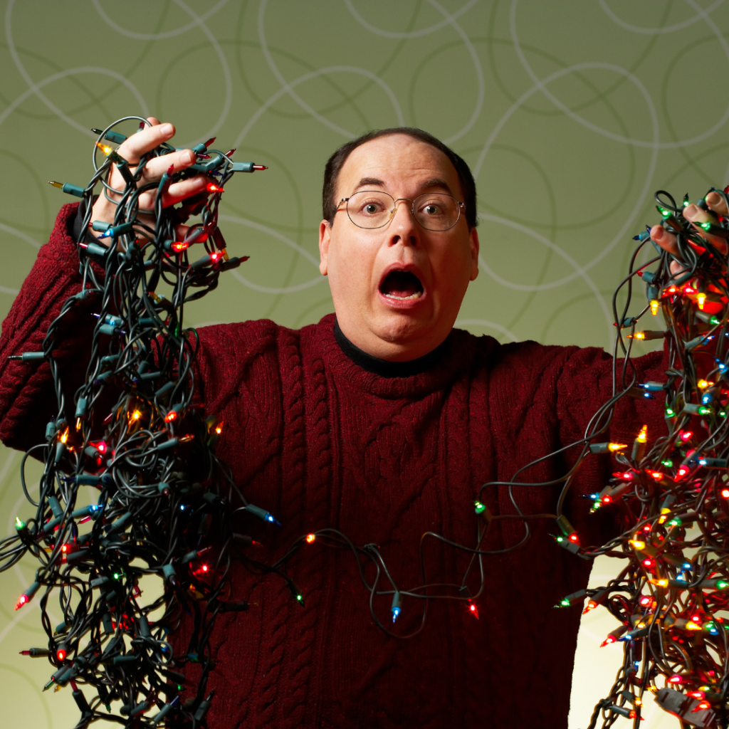 a person holding a string of tangles Christmas lights