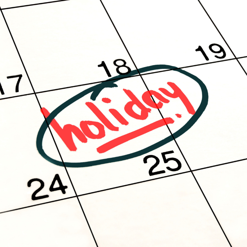 Close up of a calendar with Holiday marked in red