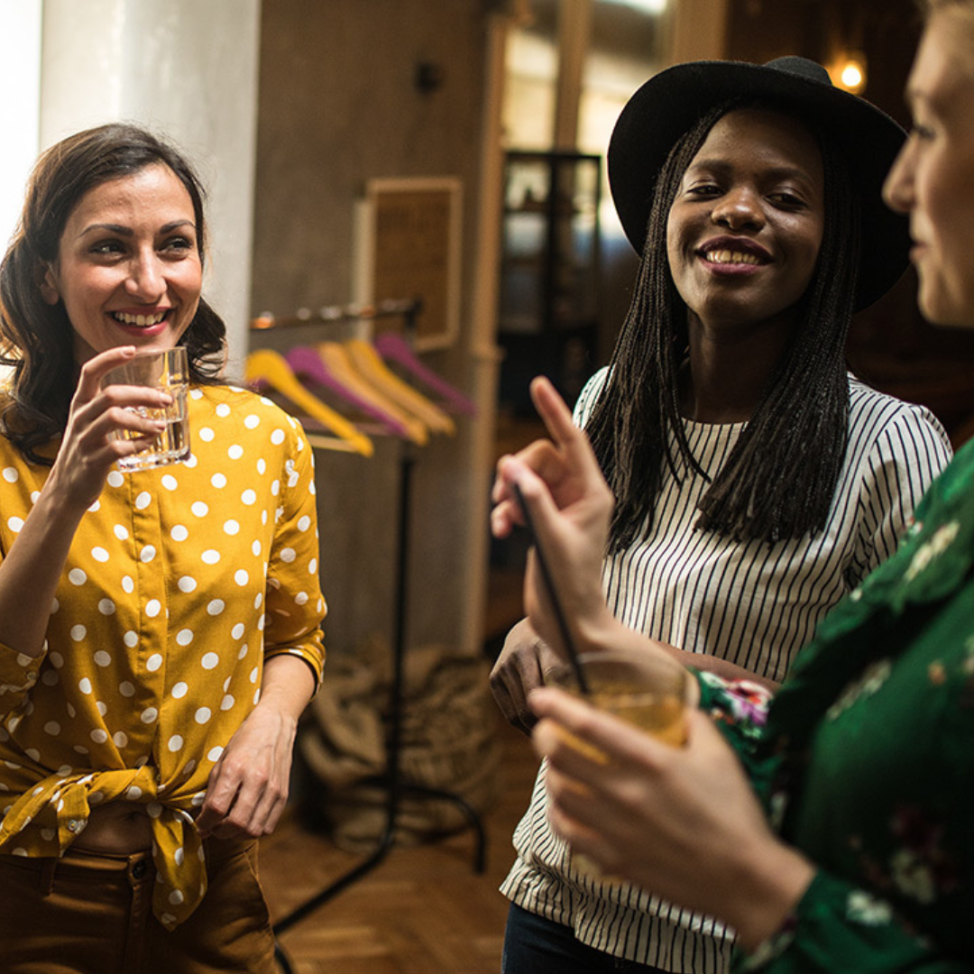 Photo of people at a party holding drinks in their hands